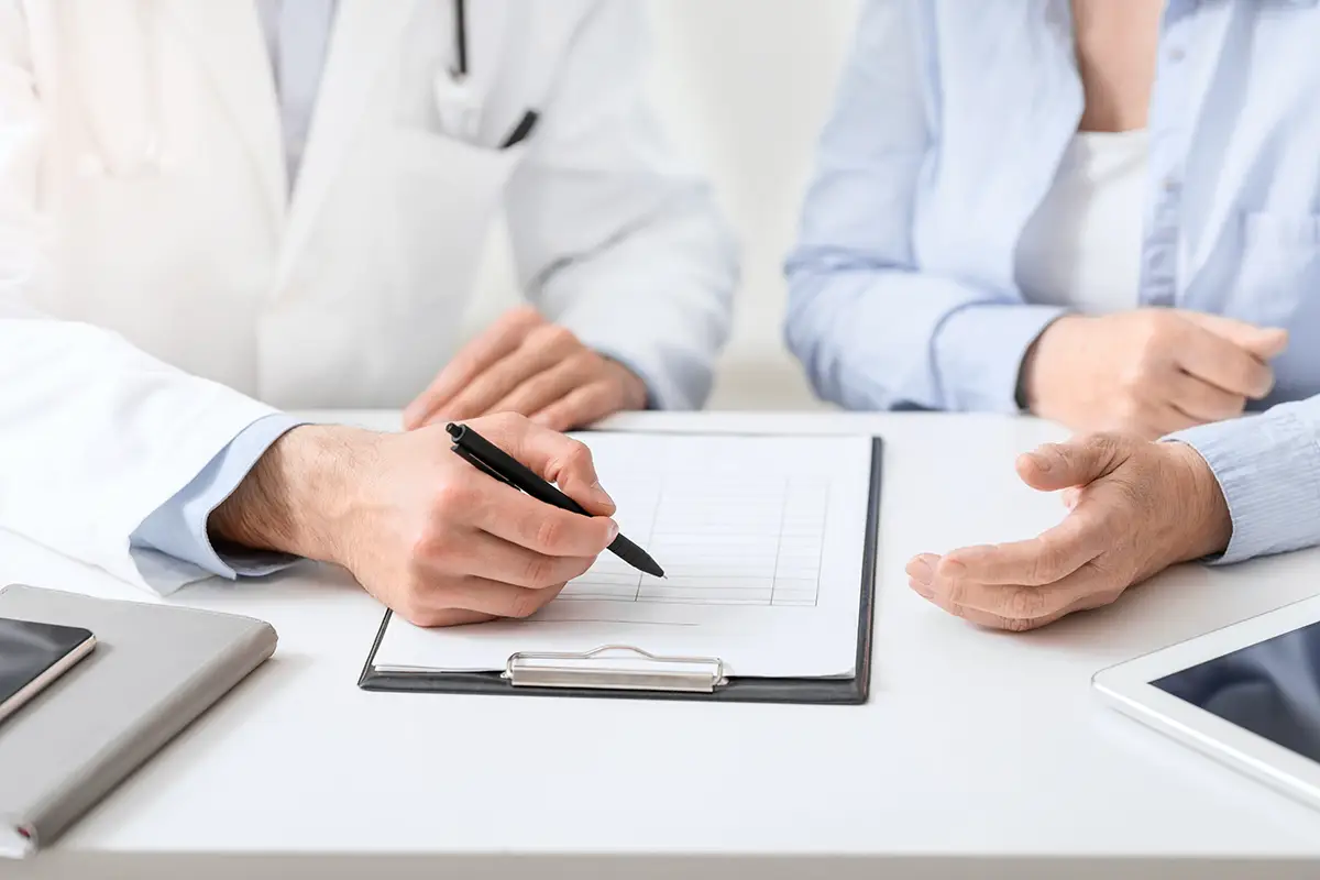 Medical contract. Doctor showing documents to female patient before treatment, close up, free space
